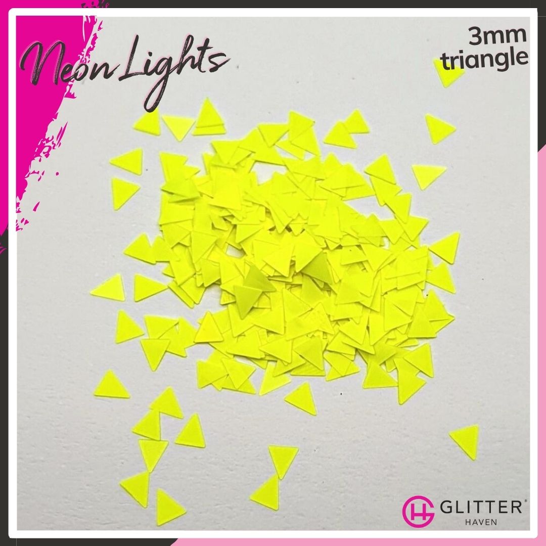 A Matte, Opaque, Traditional Glitter, mainly yellow with some Yellow, called Neon Lights in a 3mm Triangle scattered on a white background