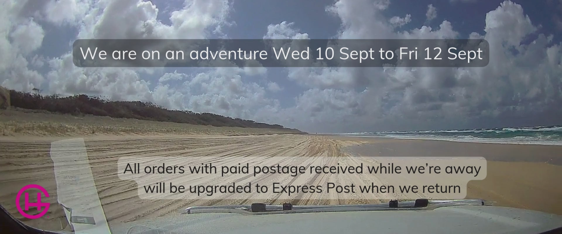 Load video: Scenic drive along an Australian beach with water splashing on the windscreen.